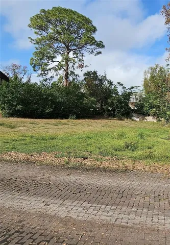 a view of a field with an ocean beach