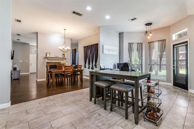 a view of a a dining hall with many windows table and chairs