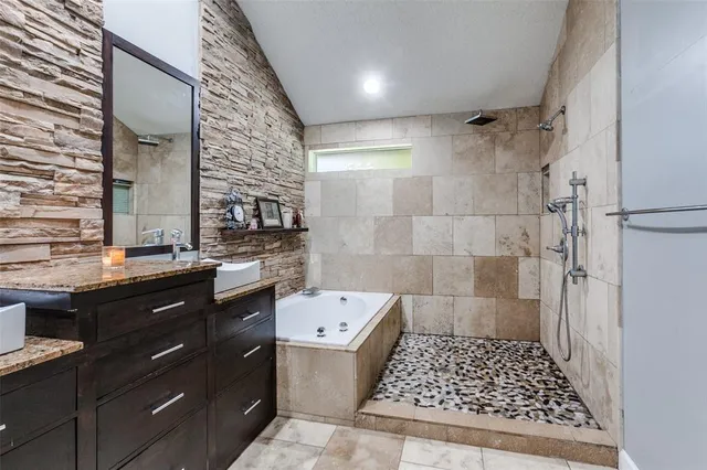 a bathroom with a sink a toilet a shower and a mirror