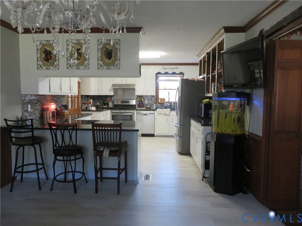 44 Adsit Lane Freeman, VA 23856 - Photo 27 of 58 a kitchen with stainless steel appliances kitchen island granite countertop a refrigerator and a stove top oven