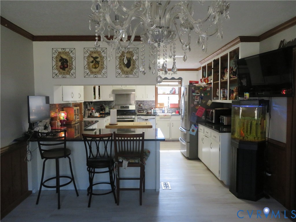 44 Adsit Lane Freeman, VA 23856 - Photo 28 of 58 a kitchen with stainless steel appliances kitchen island granite countertop a table chairs a refrigerator and a stove