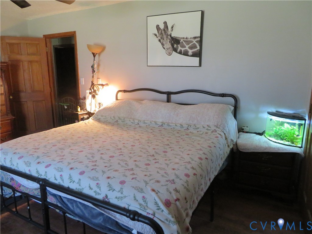 44 Adsit Lane Freeman, VA 23856 - Photo 45 of 58 a bedroom with a bed and a chandelier