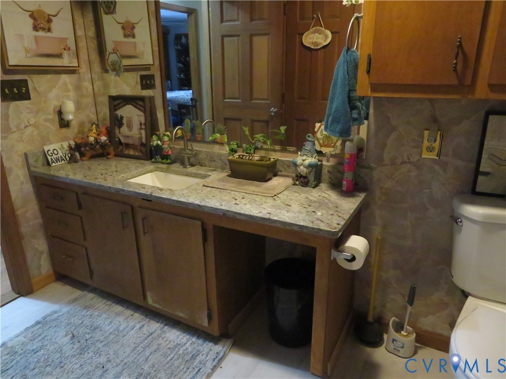44 Adsit Lane Freeman, VA 23856 - Photo 58 of 58 a bathroom with a granite countertop toilet sink and mirror