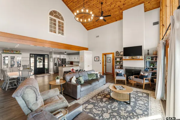 a living room with furniture and floor to ceiling windows