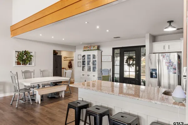 a large white kitchen with a large window