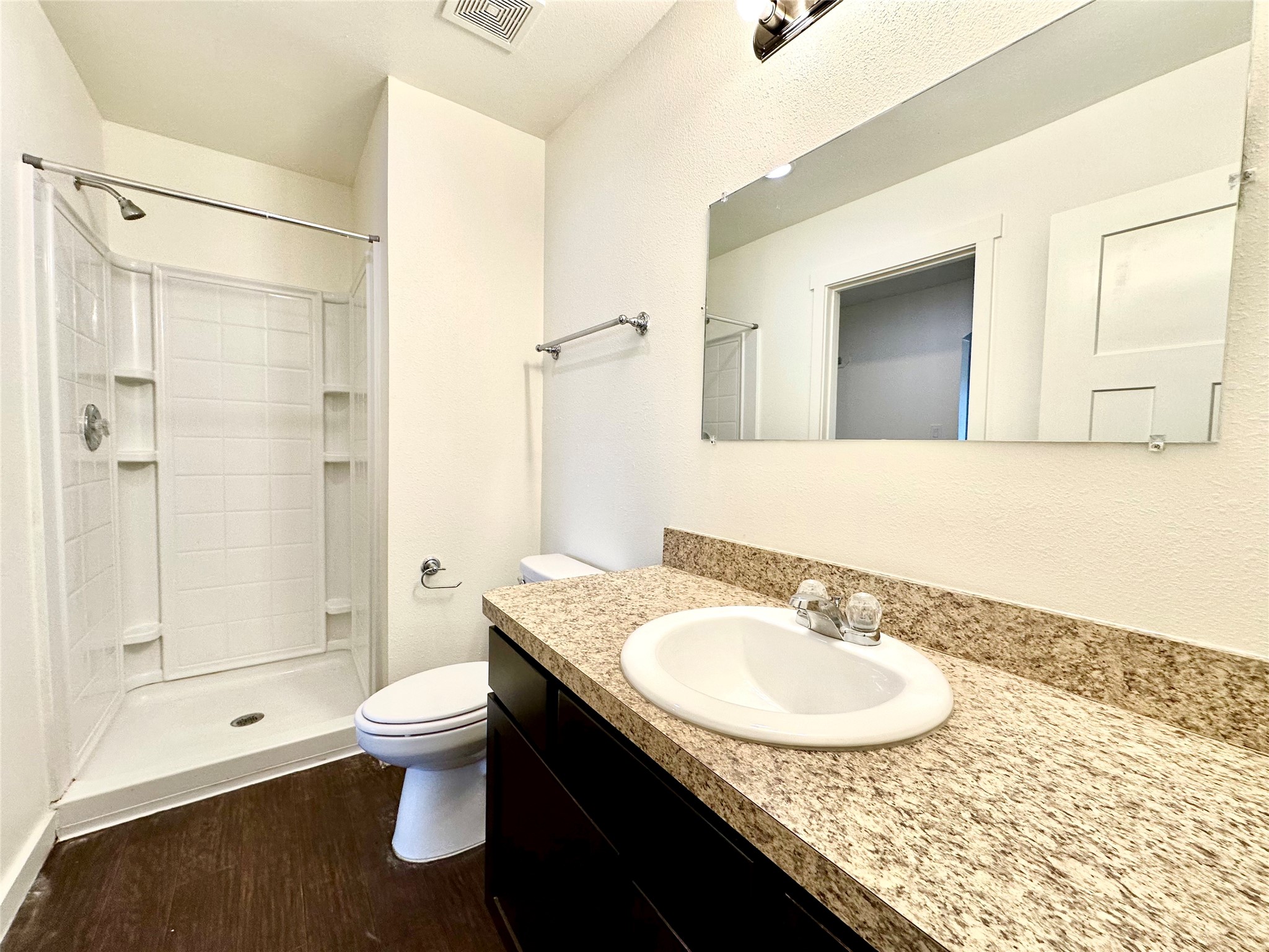 21155 Gosling Road, Unit 6C Spring, TX 77388 - Photo 11 of 20 a bathroom with a granite countertop sink a toilet a mirror and shower
