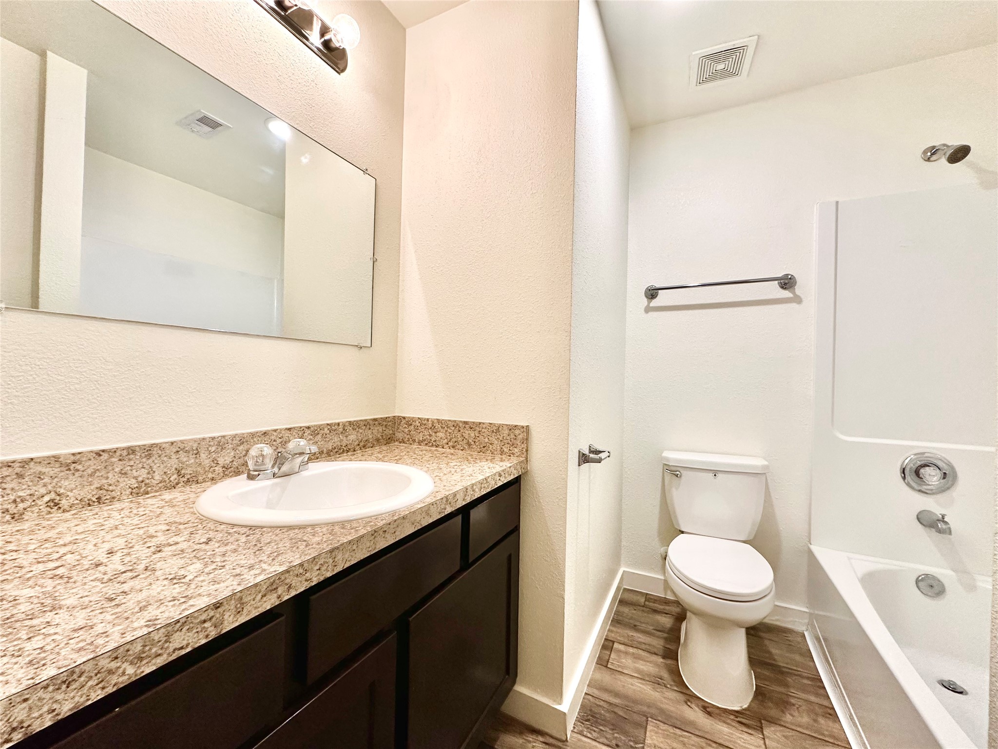 21155 Gosling Road, Unit 6C Spring, TX 77388 - Photo 16 of 20 a bathroom with a granite countertop sink toilet a large mirror and shower
