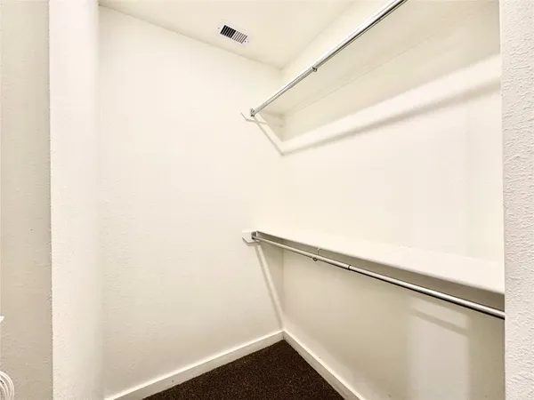 a view of closet with wooden floor