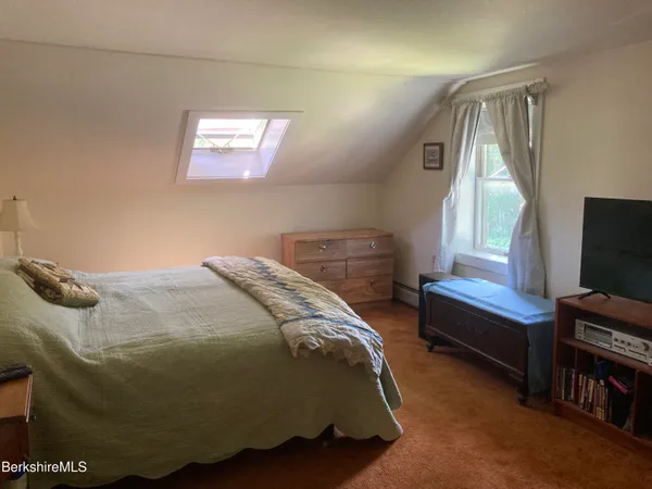 a bedroom with a bed and window