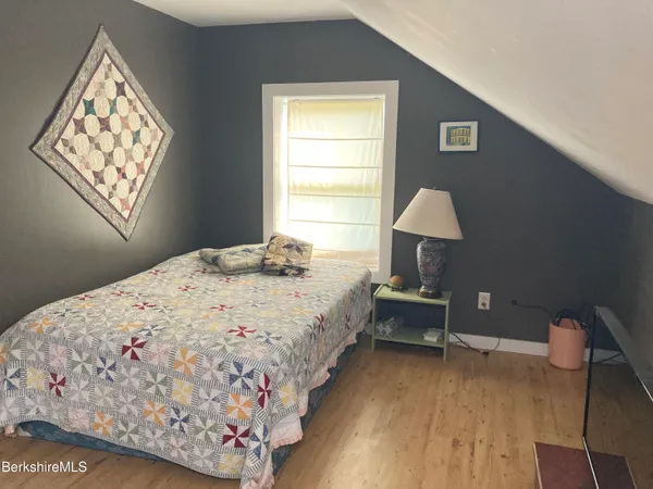 a bedroom with bed and window