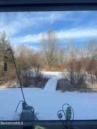 a view of a small house in middle of the forest