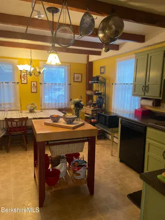 a living room with a table and chairs