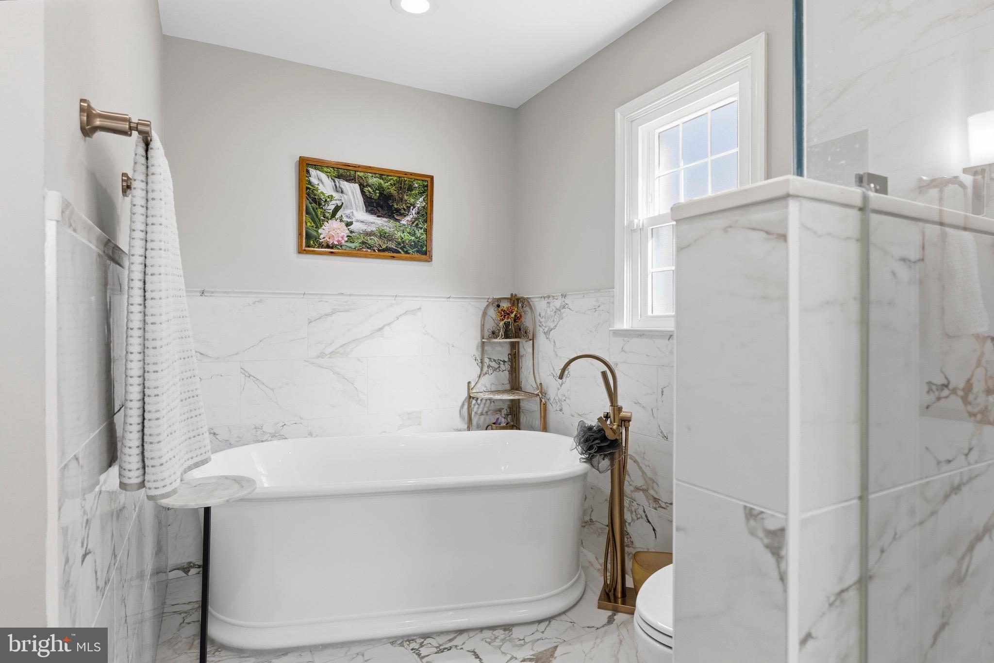 6837 White Rock Road Sykesville, MD 21784 - Photo 16 of 36 a bathroom with a sink a toilet and a window