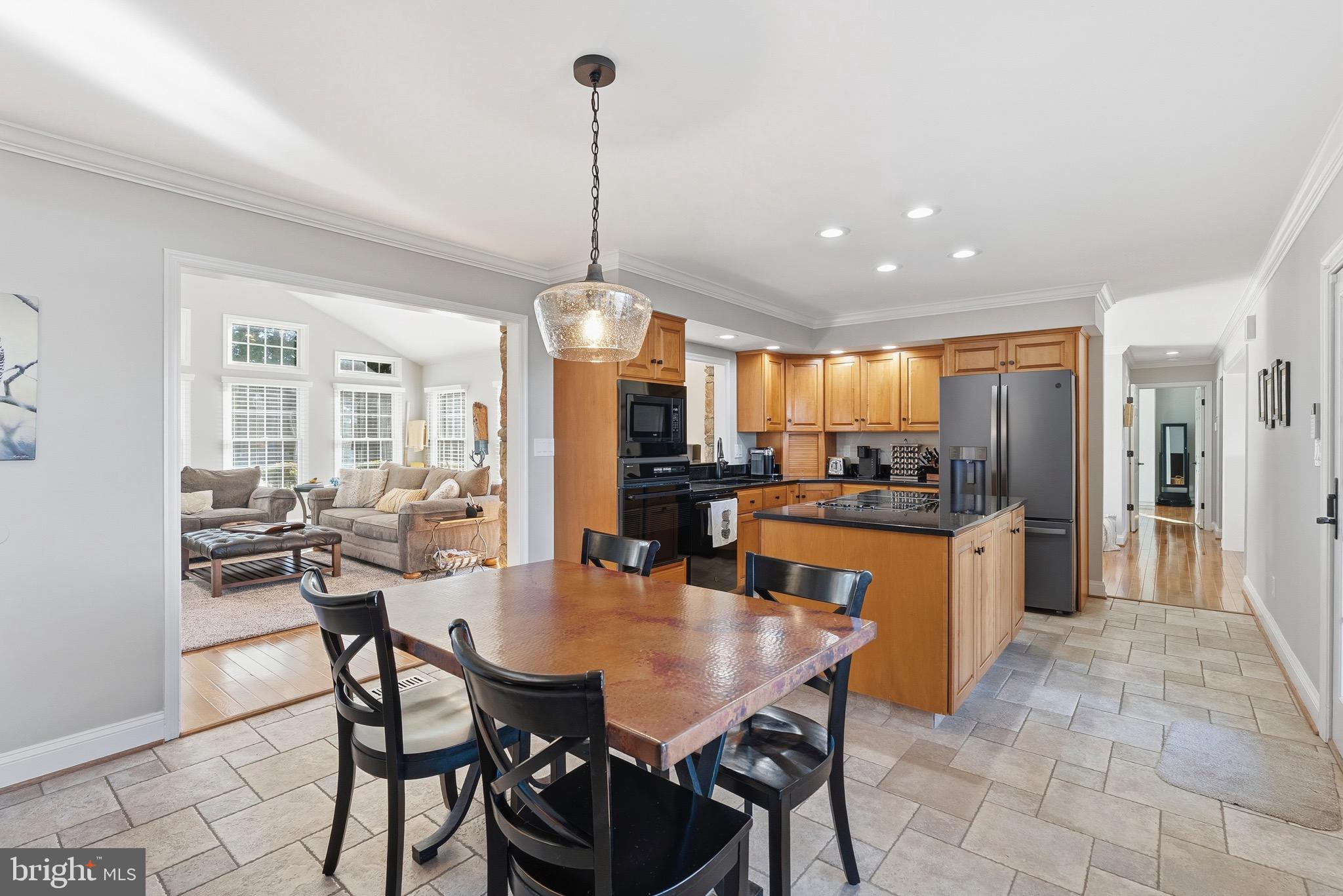 6837 White Rock Road Sykesville, MD 21784 - Photo 19 of 36 a view of a dining room and livingroom with furniture wooden floor a chandelier