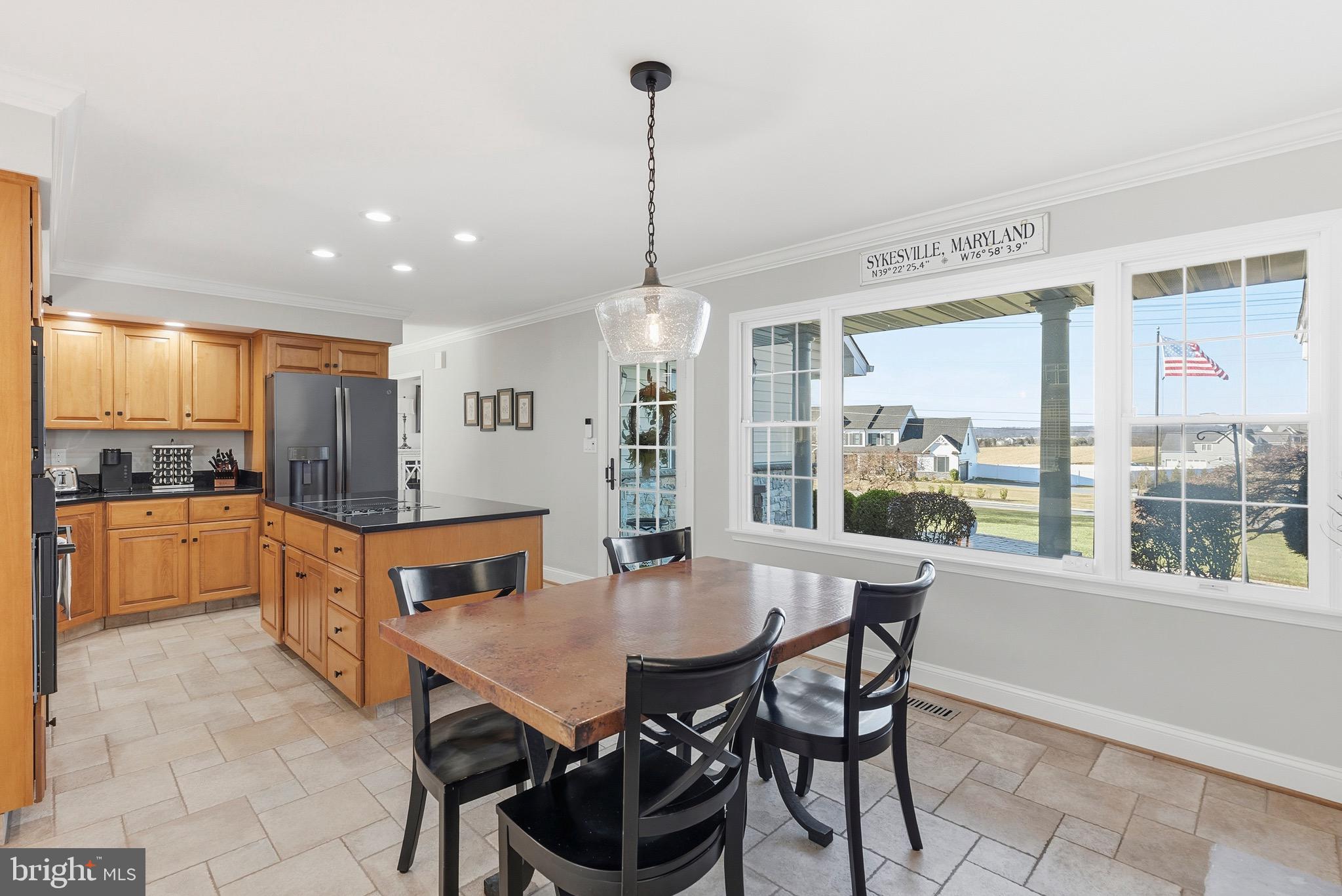 6837 White Rock Road Sykesville, MD 21784 - Photo 20 of 36 a dining room with furniture a chandelier and kitchen view