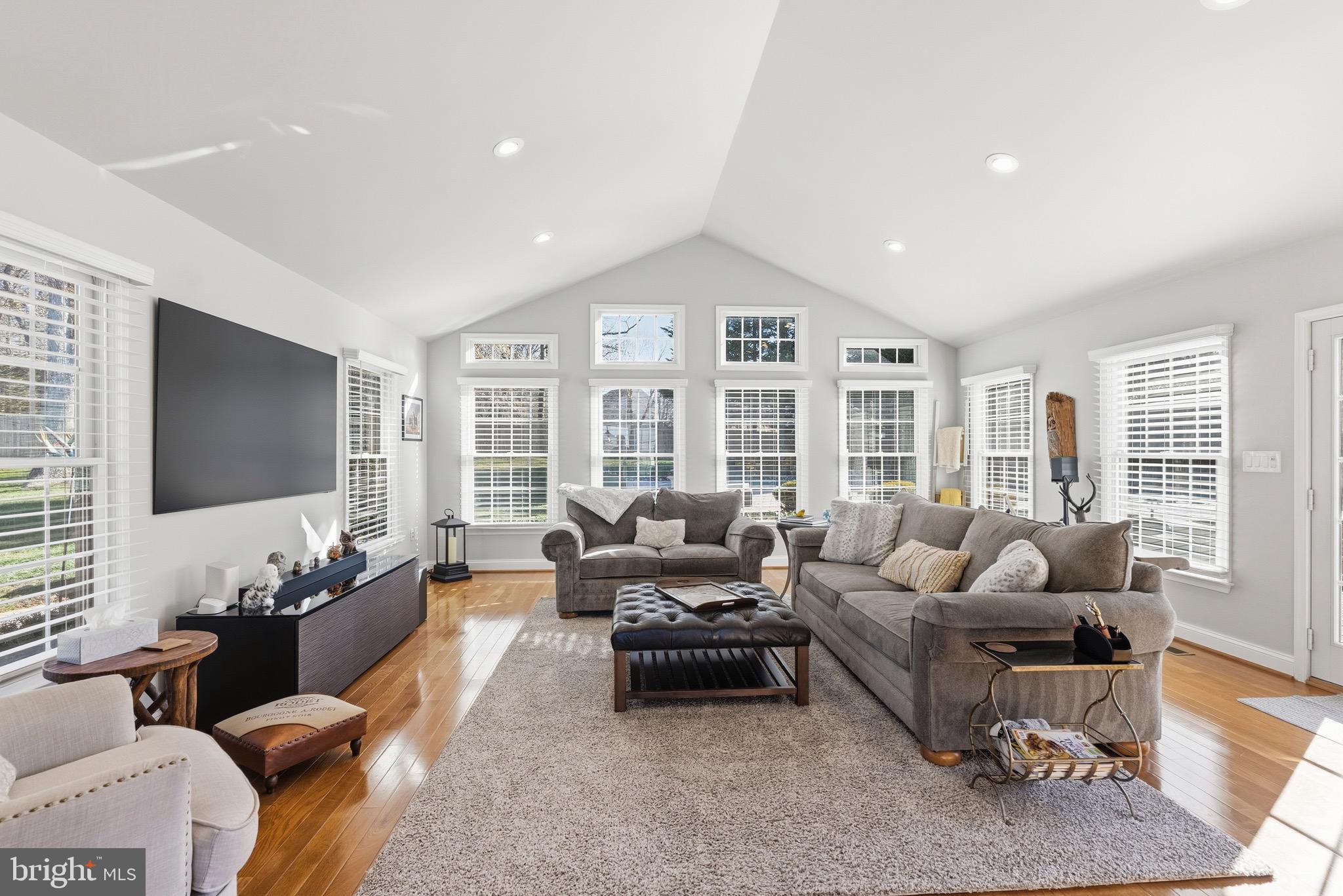 6837 White Rock Road Sykesville, MD 21784 - Photo 21 of 36 a living room with furniture floor to ceiling window and flat screen tv