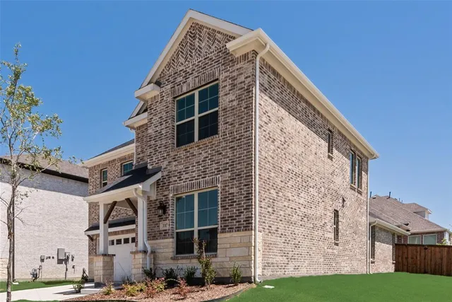 a front view of a building with a garden