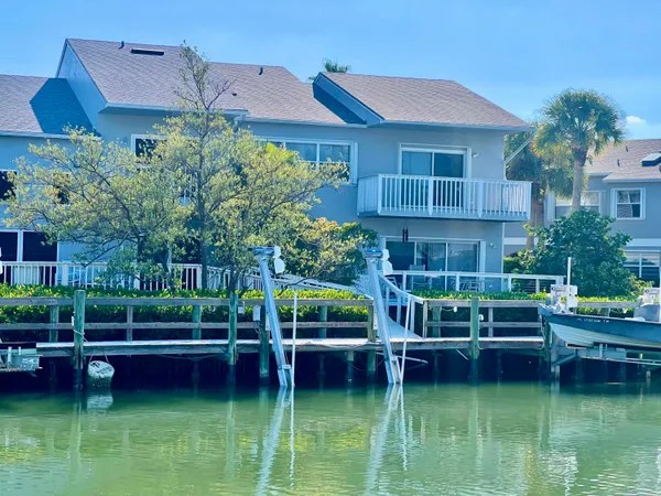 a view of a house with a yard deck and sitting area