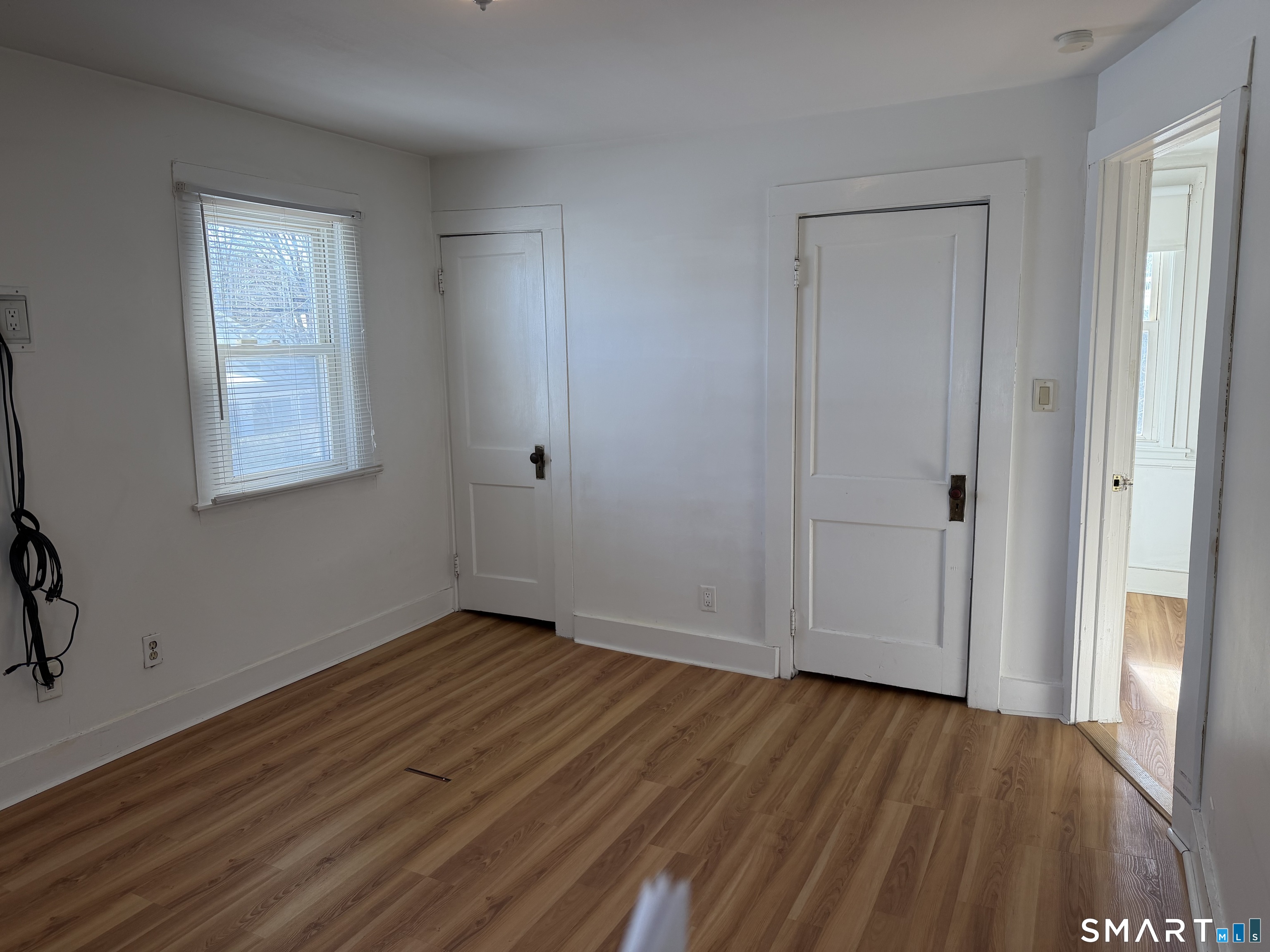 57 Chapel Street Wallingford, CT 06492 - Photo 13 of 18 an empty room with wooden floor and windows
