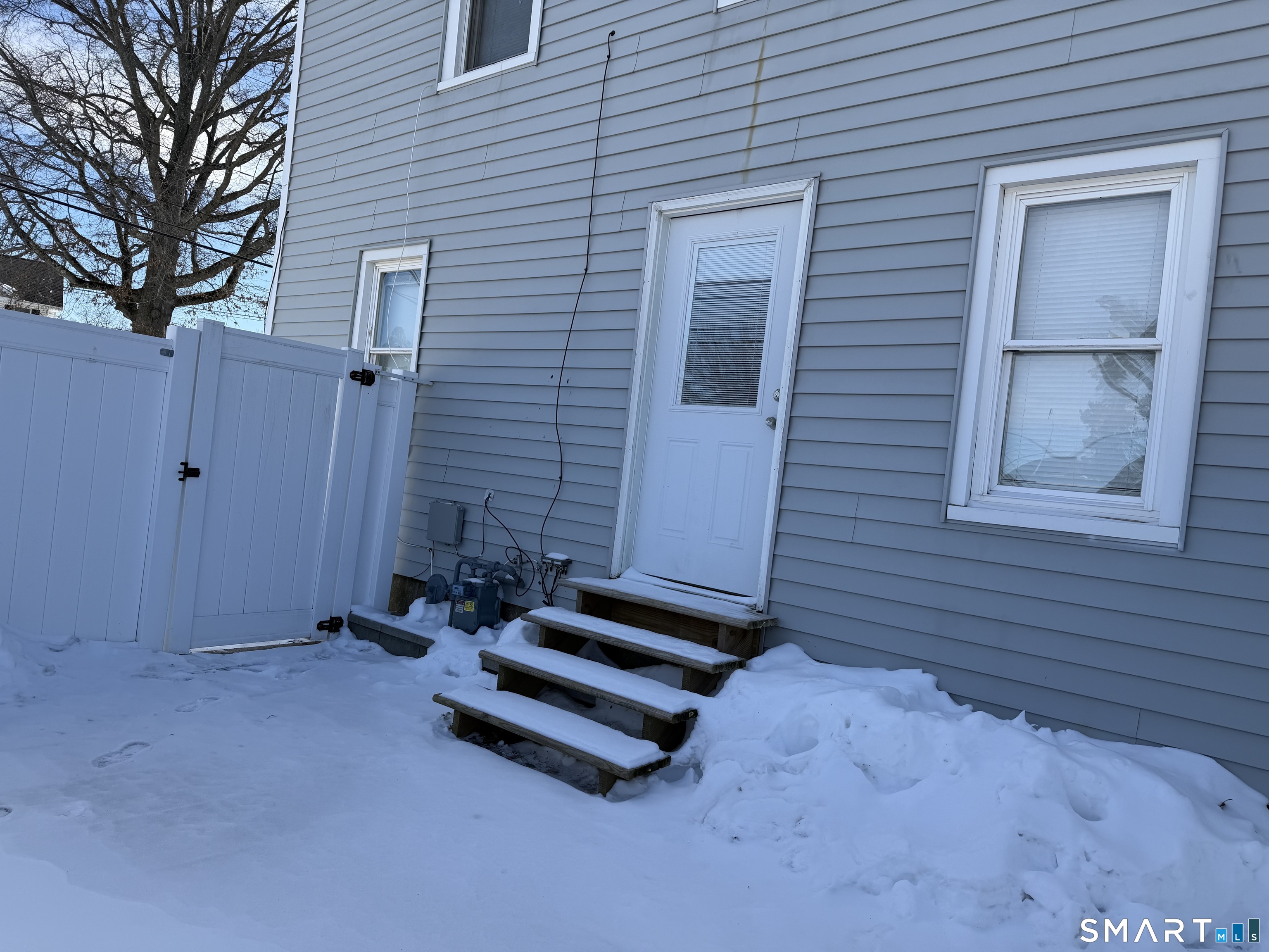 57 Chapel Street Wallingford, CT 06492 - Photo 16 of 18 a backyard of a house with table and chairs