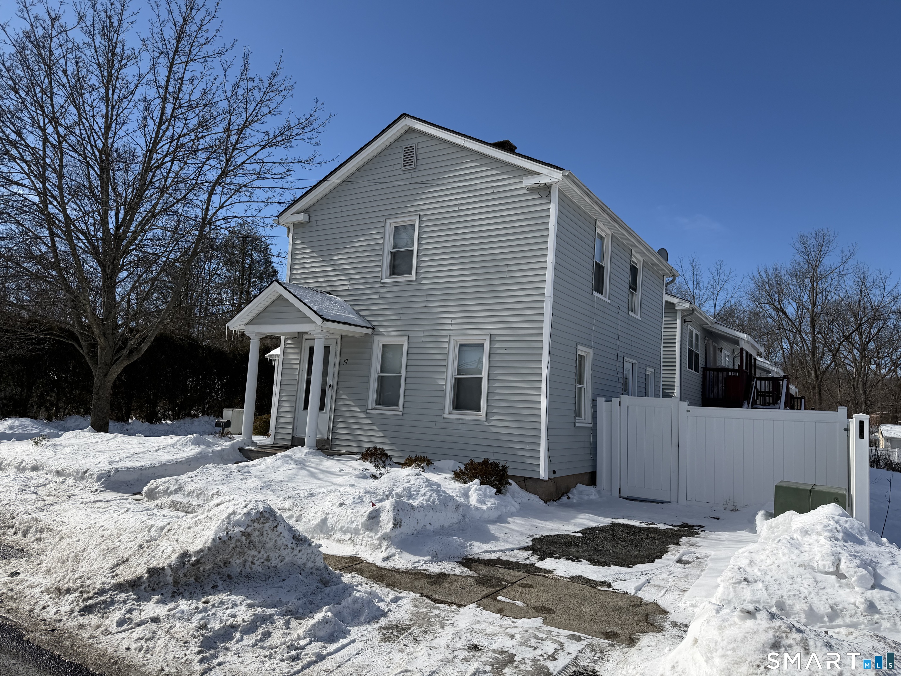 57 Chapel Street Wallingford, CT 06492 - Photo 2 of 18 a front view of a house with a yard covered in snow