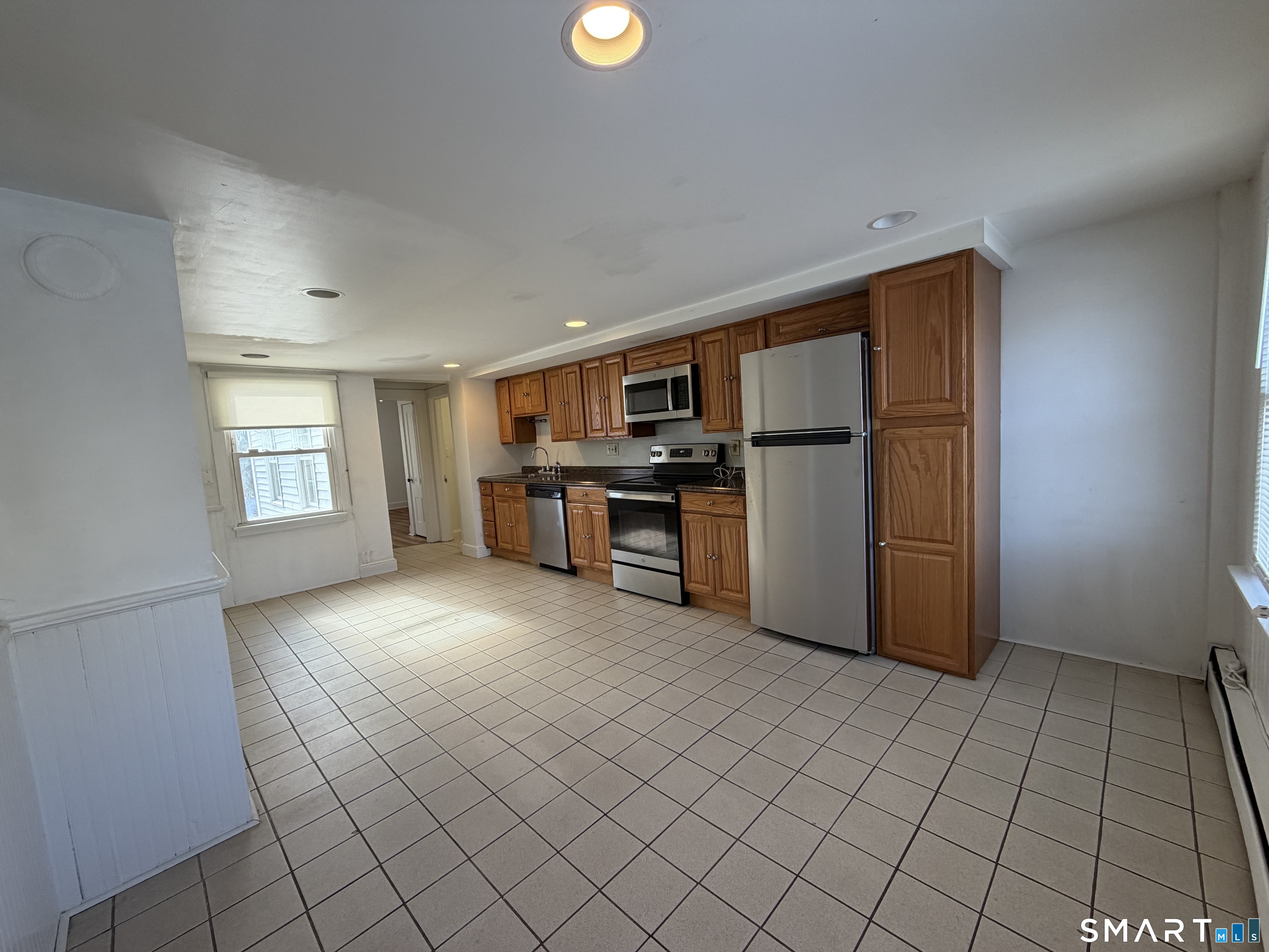 57 Chapel Street Wallingford, CT 06492 - Photo 5 of 18 a view of a kitchen with furniture and stainless steel appliances