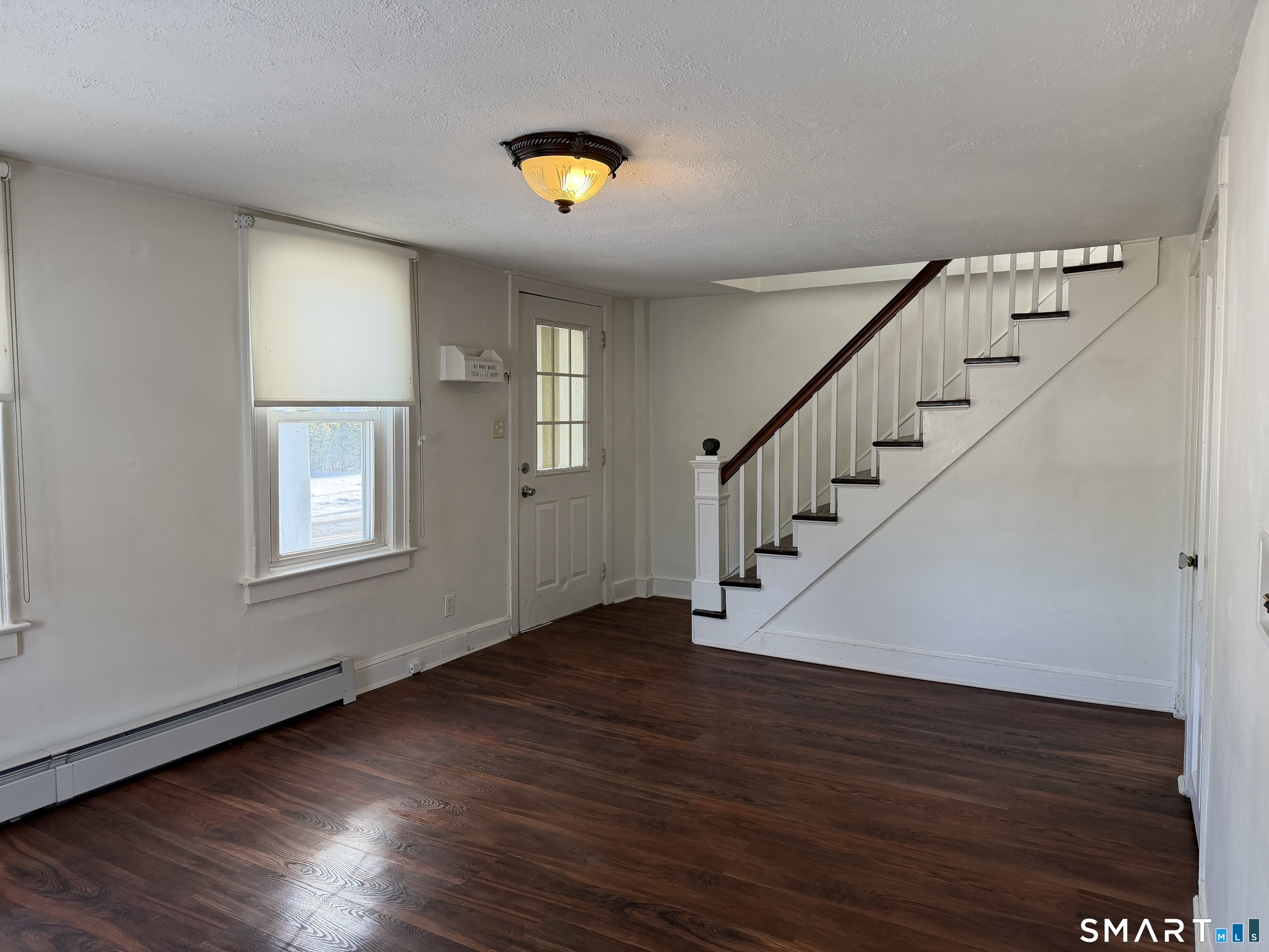 57 Chapel Street Wallingford, CT 06492 - Photo 7 of 18 a view of entryway and hall with wooden floor