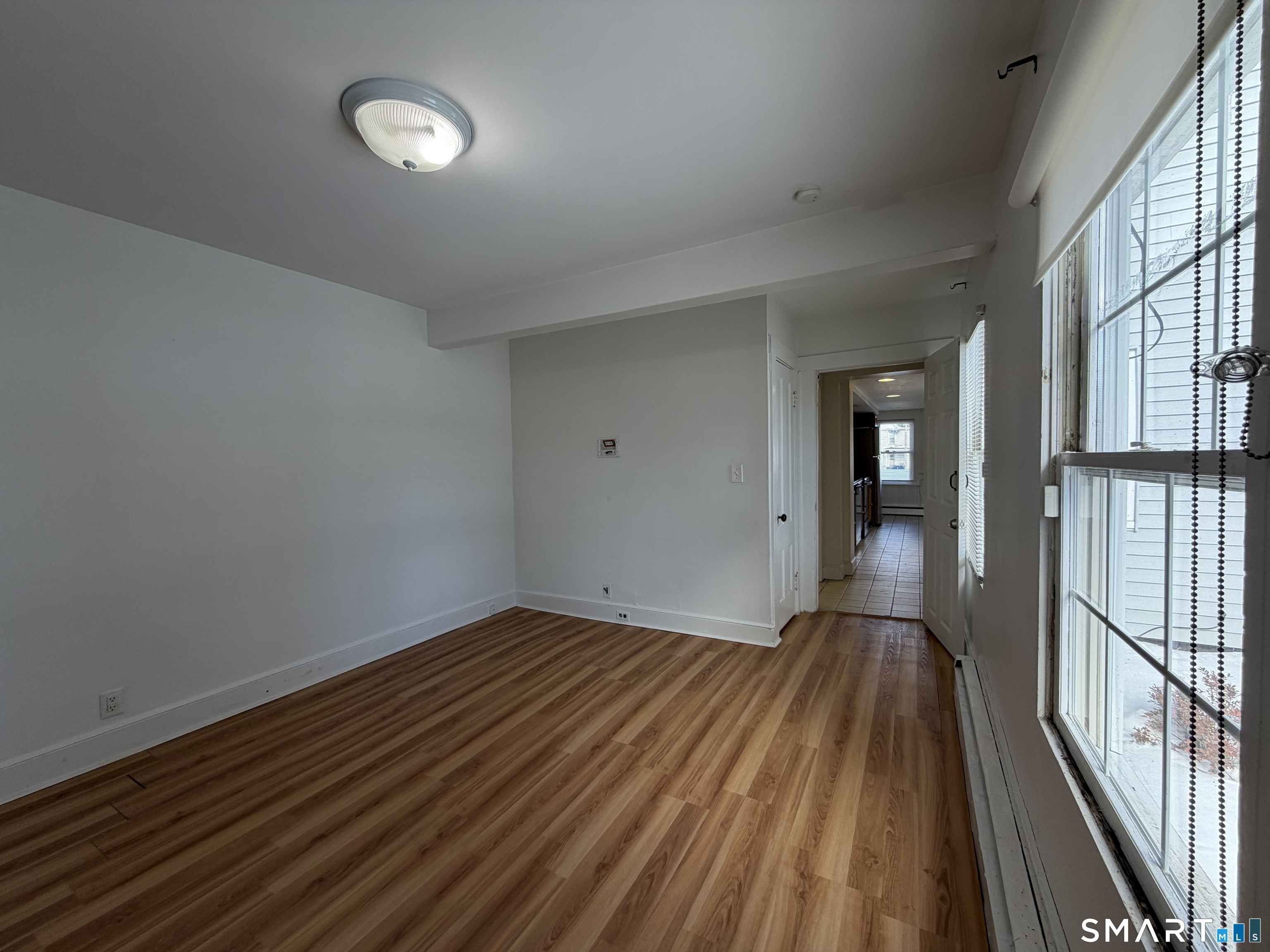 57 Chapel Street Wallingford, CT 06492 - Photo 10 of 18 a view of a room with wooden floor and a window
