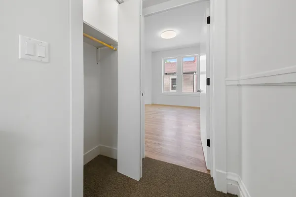 a view of a hallway with a white walls