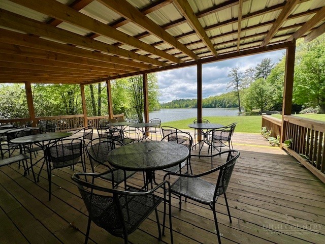 38 Rocky Meadows Road Newland, NC 28657 - Photo 45 of 50 a view of a patio with table and chairs and wooden floor