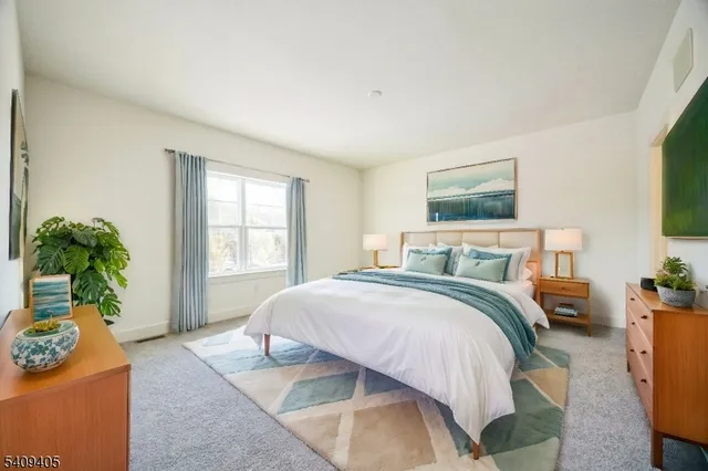 a spacious bedroom with a bed and a flat screen television