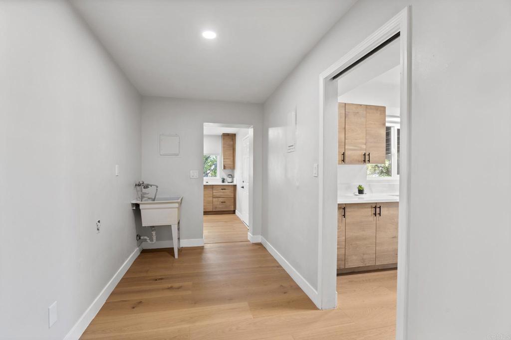 611 9th Street Ramona, CA 92065 - Photo 10 of 39 a view of a hallway with wooden floor and a bathroom
