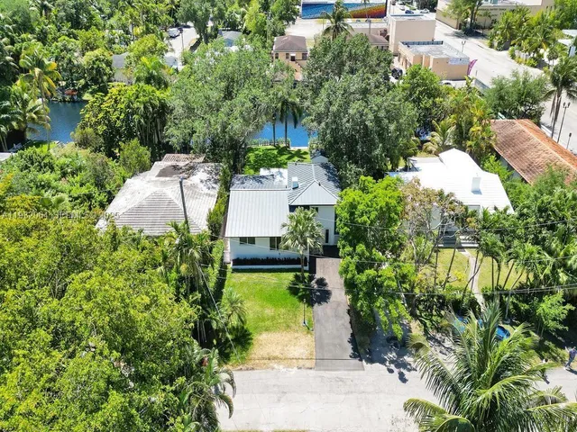 an aerial view of a house with garden space and street view