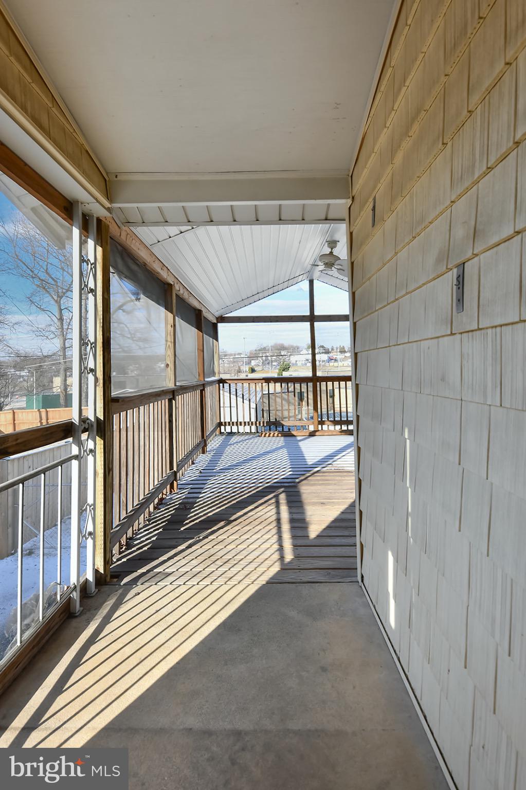 112 Linhigh Avenue Nottingham, MD 21236 - Photo 14 of 45 Sunlit porch with scenic views ahead.