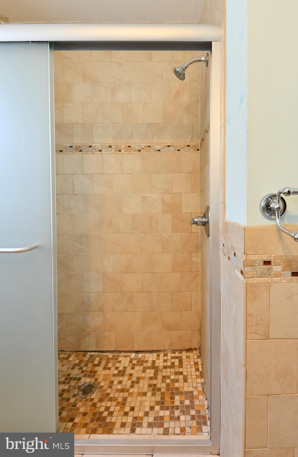112 Linhigh Avenue Nottingham, MD 21236 - Photo 25 of 45 Elegant tiled shower with modern glass doors.