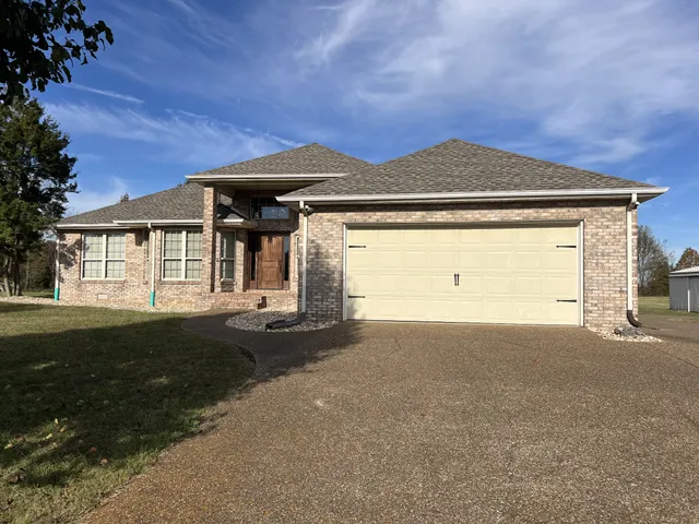 a front view of a house with yard