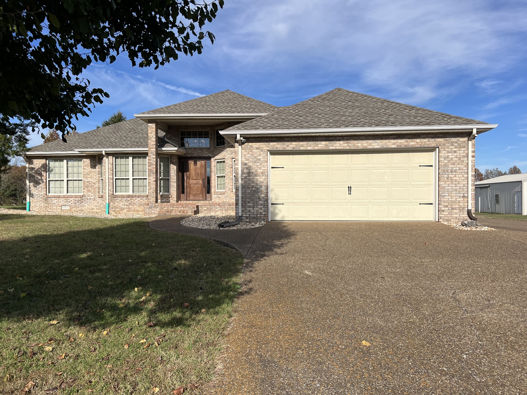 3716 Scottsville Road Lafayette, TN 37083 - Photo 3 of 21 a front view of a house with a garden and yard