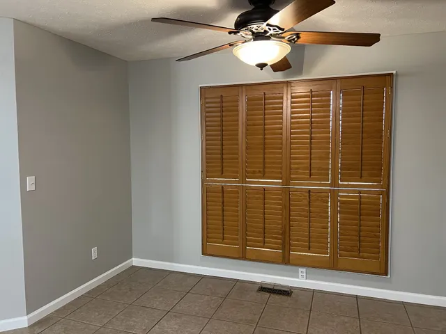 a kitchen with kitchen island granite countertop a sink and a refrigerator