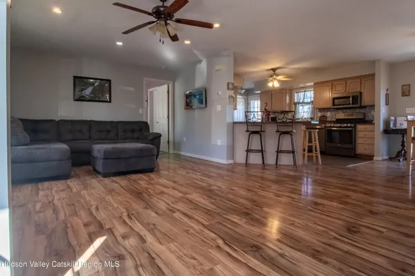 a living room with furniture and kitchen view