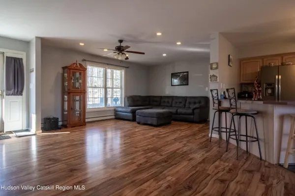 a living room with furniture window and wooden floor