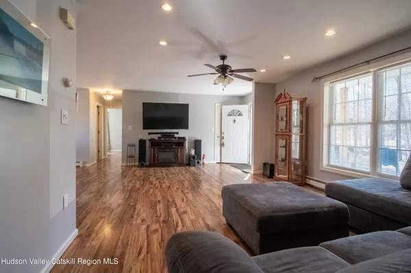 a living room with furniture and a flat screen tv