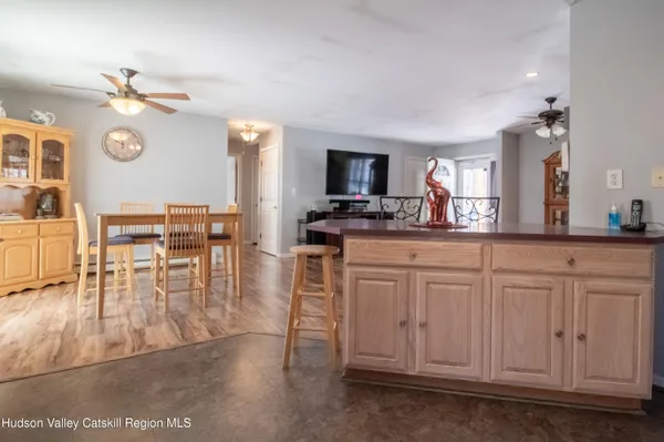 a kitchen with white cabinets and chandelier