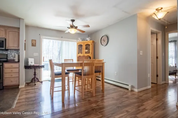 a view of a dining room with furniture and wooden floor