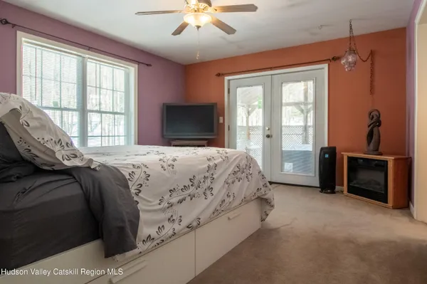 a bedroom with a bed and a television