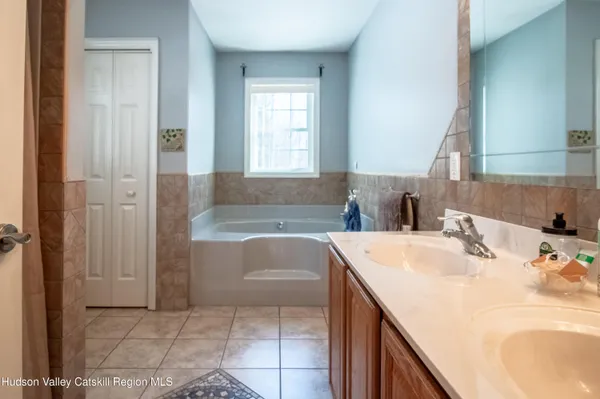 a bathroom with a bathtub sink and mirror