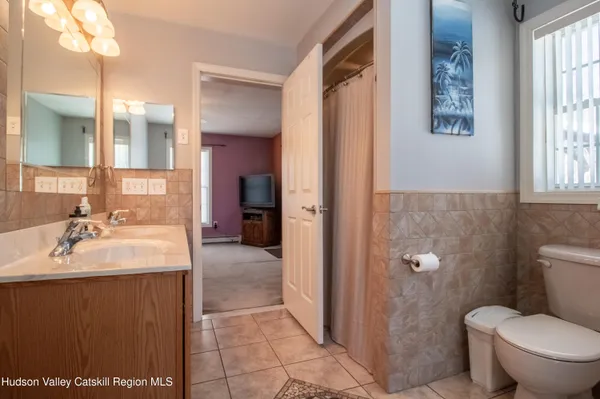 a spacious bathroom with a sink toilet and shower