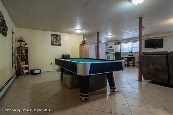 a room with gym equipment and a flat screen tv