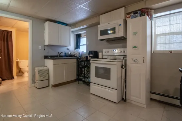 a kitchen with stainless steel appliances white cabinets and a window