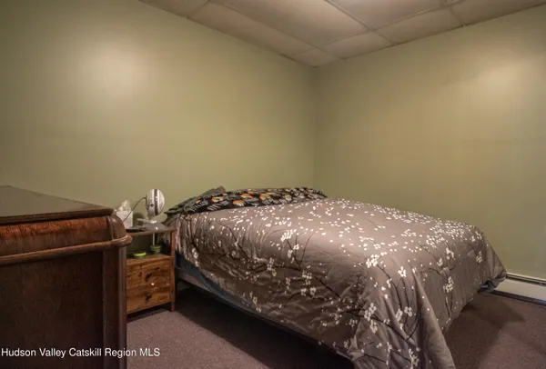 a bed sitting in a bedroom next to a lamp