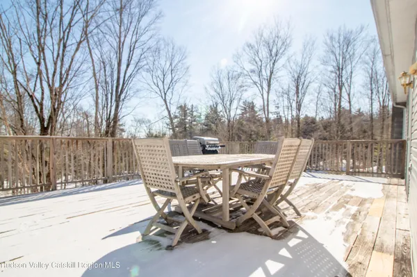 a view of a patio with table and chairs and wooden fence